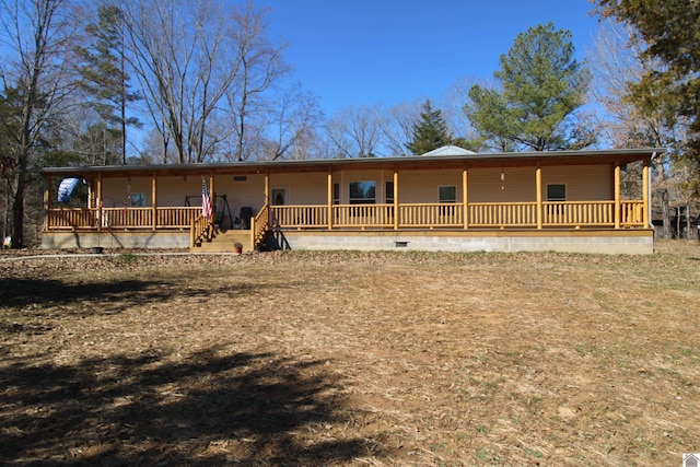 view of front of house featuring crawl space, a porch, and metal roof