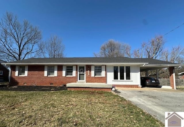 ranch-style home with an attached carport, concrete driveway, a front yard, crawl space, and brick siding