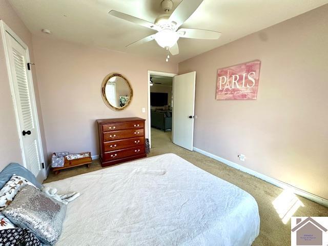 bedroom with ceiling fan, baseboards, and carpet floors