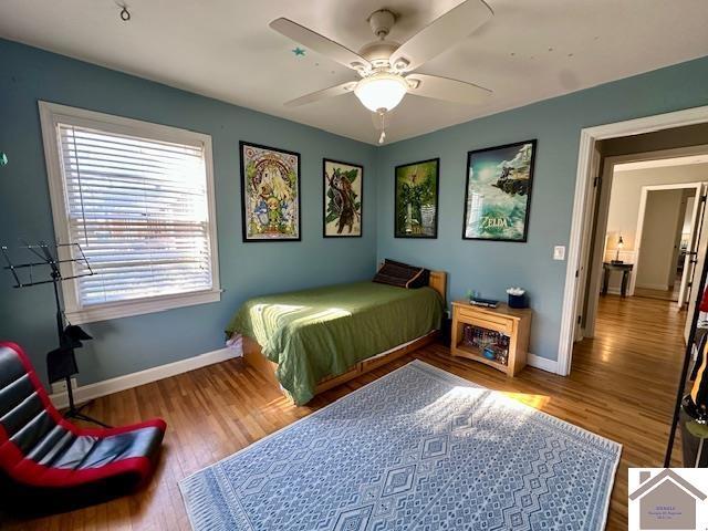 bedroom with wood finished floors, baseboards, and ceiling fan