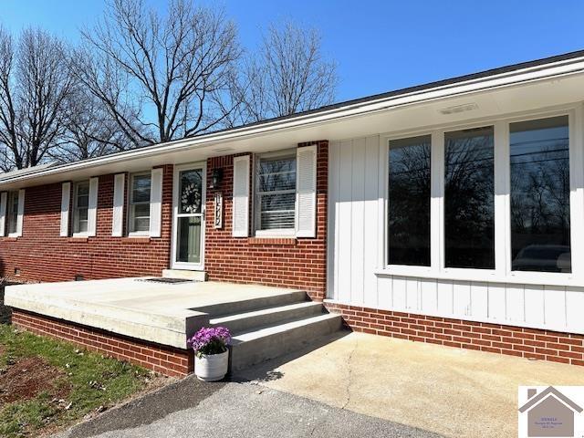 view of front of house featuring brick siding