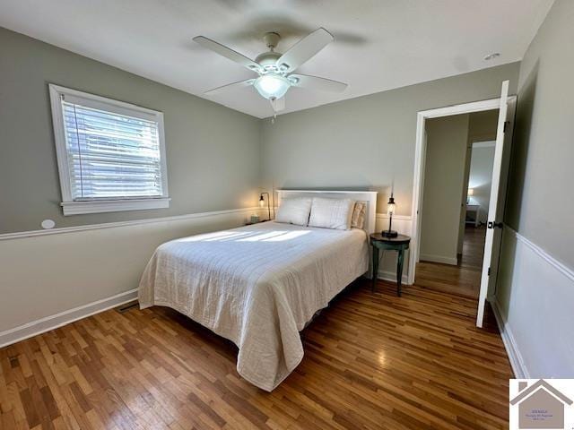 bedroom with ceiling fan, baseboards, and wood finished floors