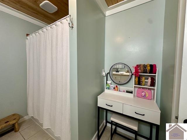 bathroom featuring tile patterned floors, visible vents, baseboards, and a shower with curtain