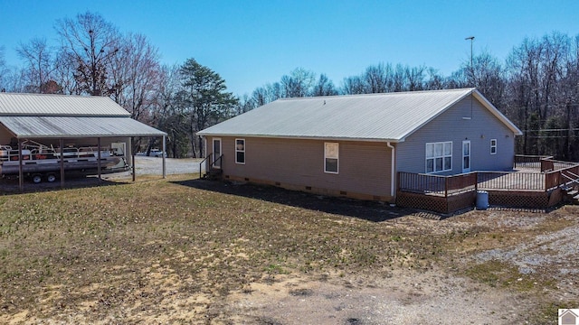 view of side of home featuring crawl space, metal roof, and a deck