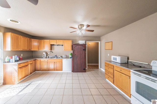 kitchen with white appliances, light tile patterned floors, a ceiling fan, visible vents, and a sink