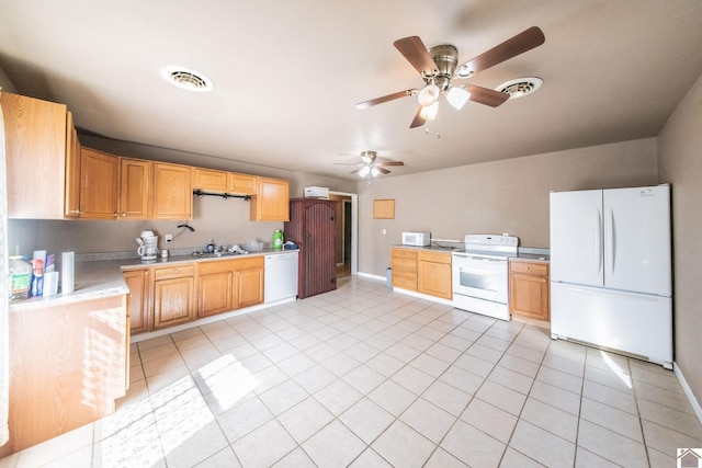 kitchen with white appliances, light tile patterned floors, visible vents, baseboards, and light countertops