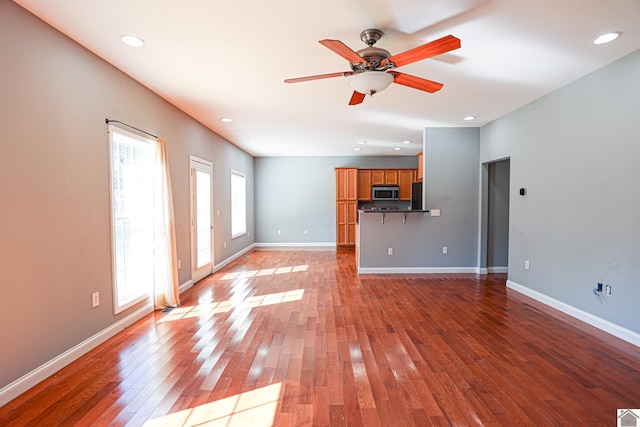 unfurnished living room featuring recessed lighting, baseboards, light wood-style flooring, and ceiling fan