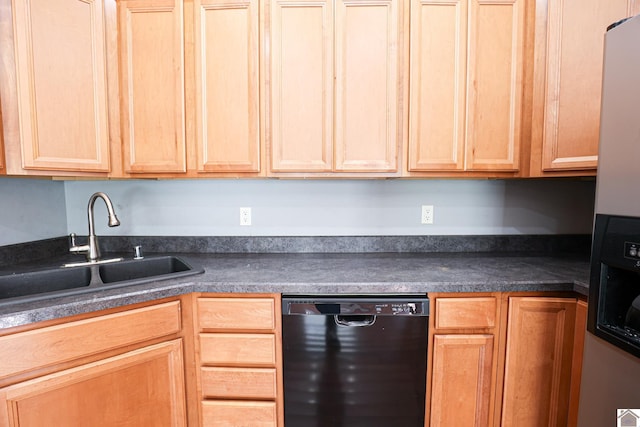 kitchen with dark countertops, black dishwasher, and a sink