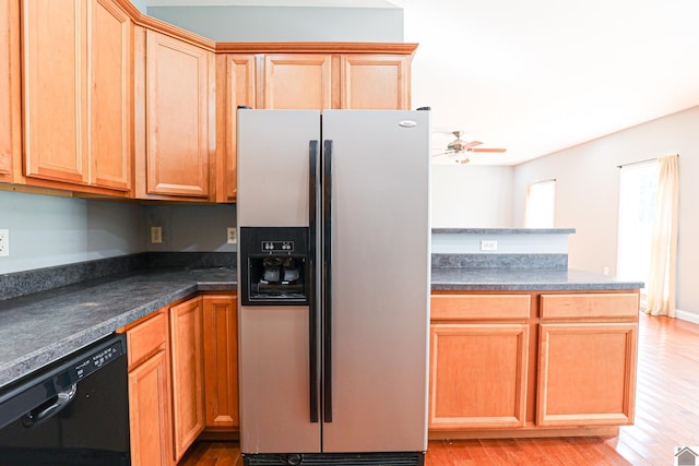 kitchen featuring dark countertops, ceiling fan, stainless steel fridge with ice dispenser, light wood-type flooring, and black dishwasher