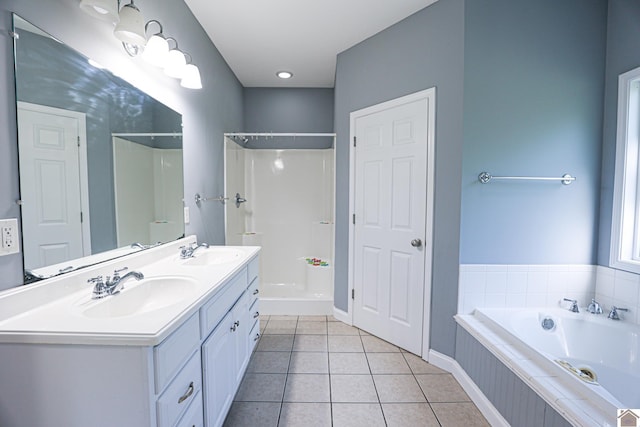 full bathroom with a sink, a shower, tiled bath, and tile patterned flooring