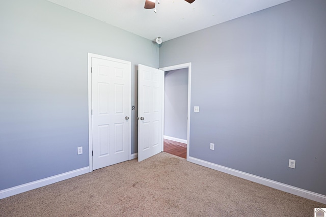 unfurnished bedroom with ceiling fan, baseboards, and carpet floors