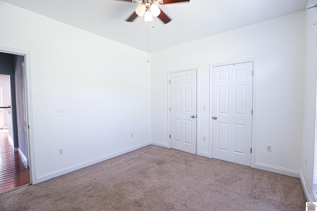 unfurnished bedroom featuring ceiling fan, baseboards, and carpet