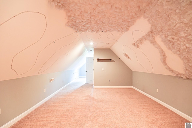 bonus room with light colored carpet, baseboards, and vaulted ceiling