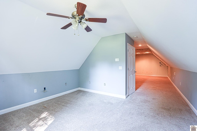 bonus room with vaulted ceiling, carpet flooring, baseboards, and ceiling fan