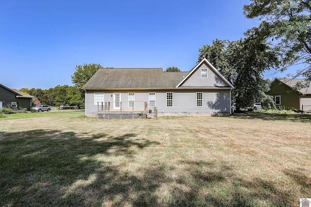 rear view of house featuring a yard and a wooden deck