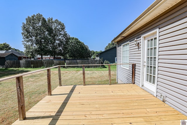 wooden terrace with a yard and fence