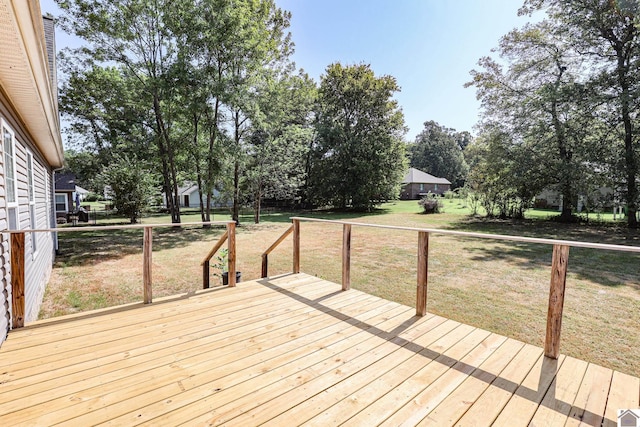 wooden terrace featuring a yard