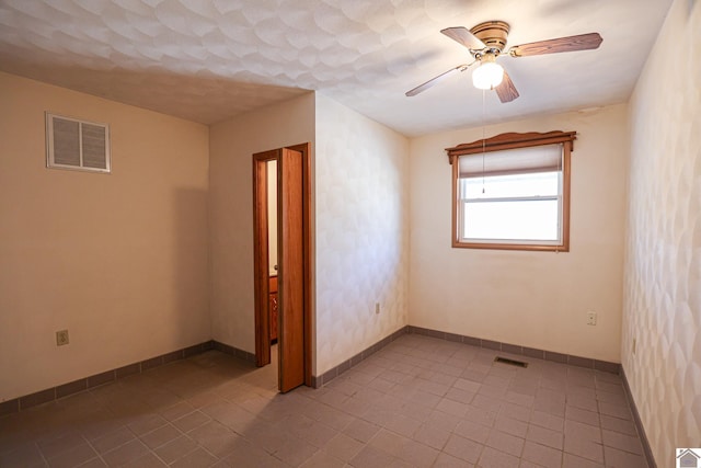 spare room with visible vents, baseboards, ceiling fan, and tile patterned flooring