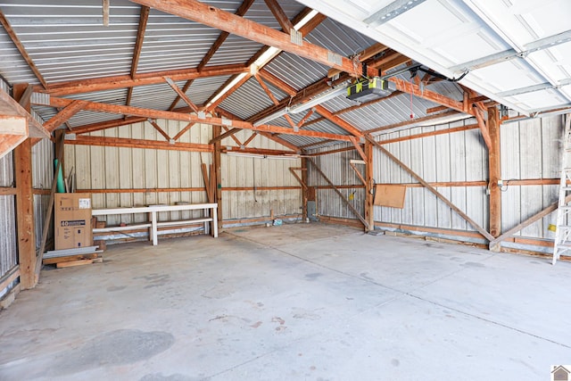 garage with metal wall and a garage door opener