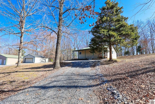 view of front of property with a porch, an outdoor structure, and a garage