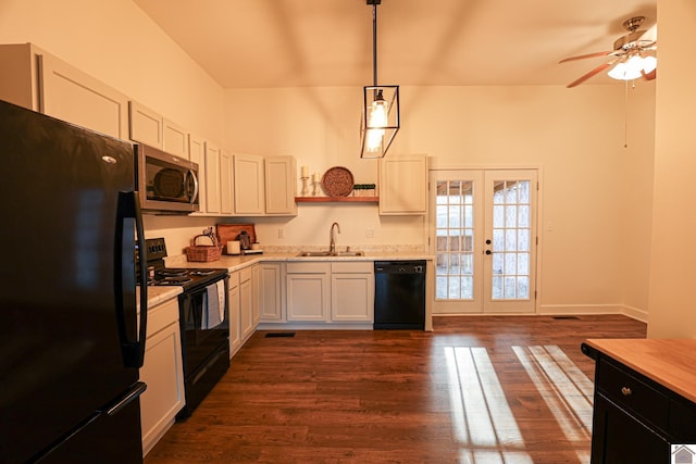 kitchen with a sink, dark wood-type flooring, light countertops, black appliances, and open shelves