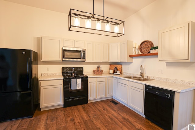 kitchen with a sink, dark wood finished floors, light countertops, black appliances, and open shelves