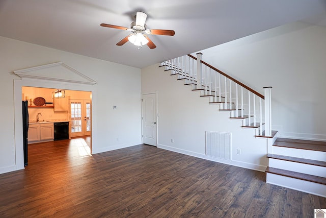 unfurnished living room featuring stairs, visible vents, dark wood-style flooring, and a sink