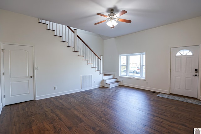 foyer entrance with stairway, dark wood-style floors, visible vents, and baseboards