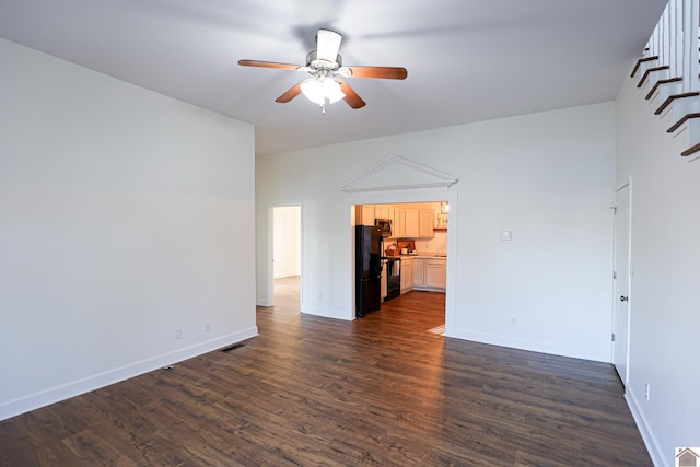 unfurnished living room featuring visible vents, dark wood-style floors, baseboards, and ceiling fan