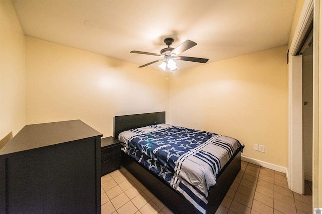 bedroom with light tile patterned floors, baseboards, and ceiling fan