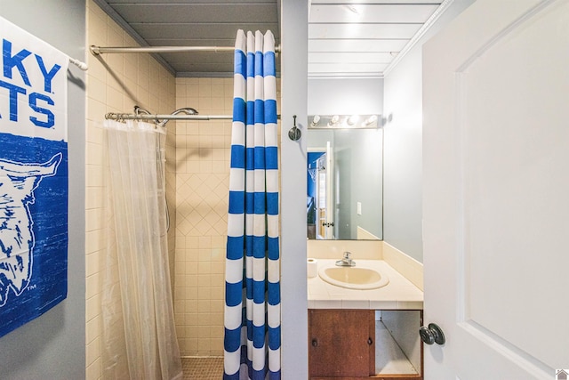 full bathroom featuring vanity and a tile shower