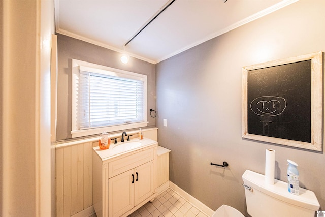 bathroom with crown molding, baseboards, toilet, tile patterned floors, and vanity