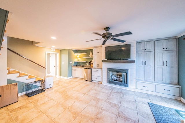 unfurnished living room with ceiling fan, baseboards, stairway, light tile patterned floors, and a fireplace