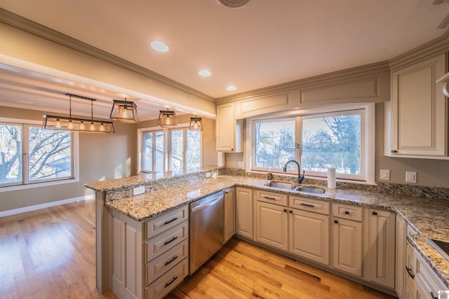 kitchen with crown molding, dishwasher, a peninsula, light wood-style floors, and a sink