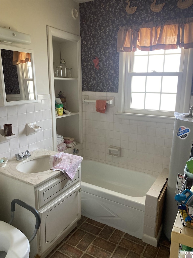 full bath featuring wainscoting, gas water heater, wallpapered walls, and tile walls