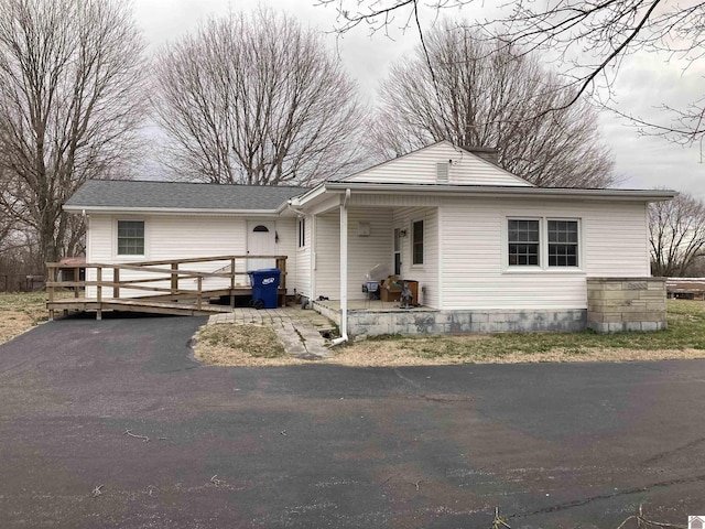 view of front of house with a wooden deck and driveway