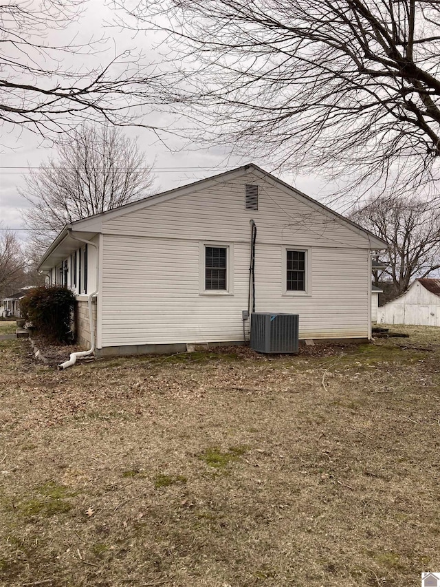 view of side of property featuring central air condition unit