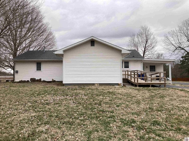 rear view of house featuring a yard and a deck