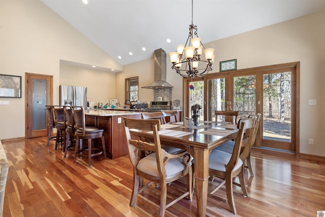 dining space with recessed lighting, baseboards, high vaulted ceiling, and light wood-style flooring