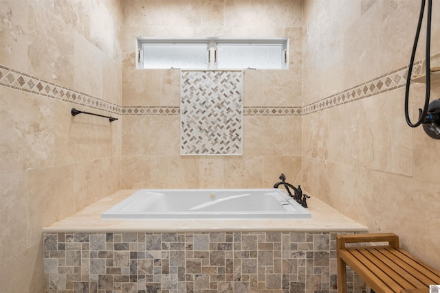 bathroom featuring tile walls and a bath