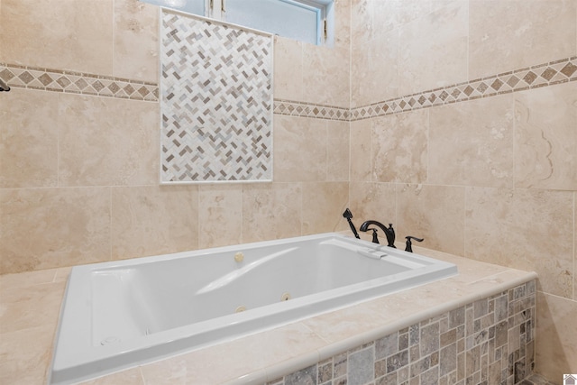 bathroom featuring tile walls and a whirlpool tub