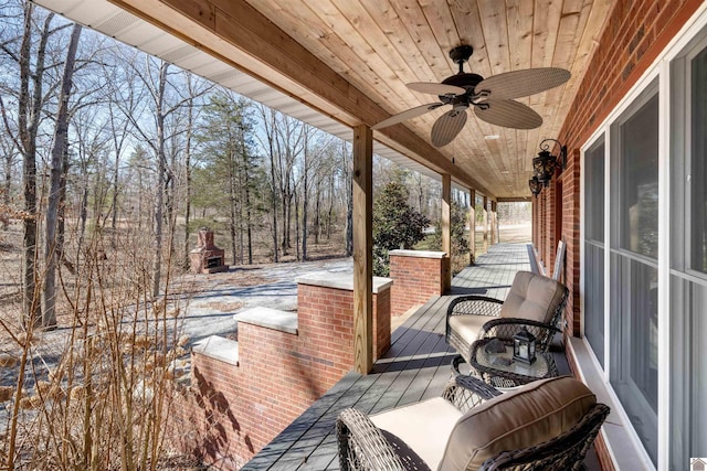 wooden terrace featuring ceiling fan