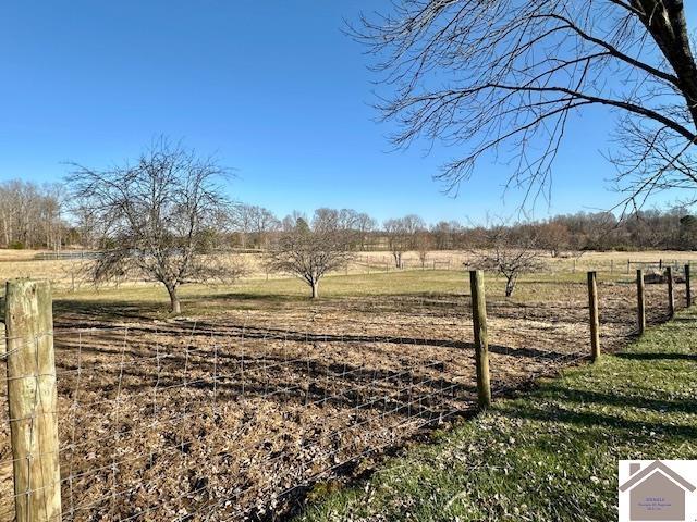 view of yard featuring a rural view and fence