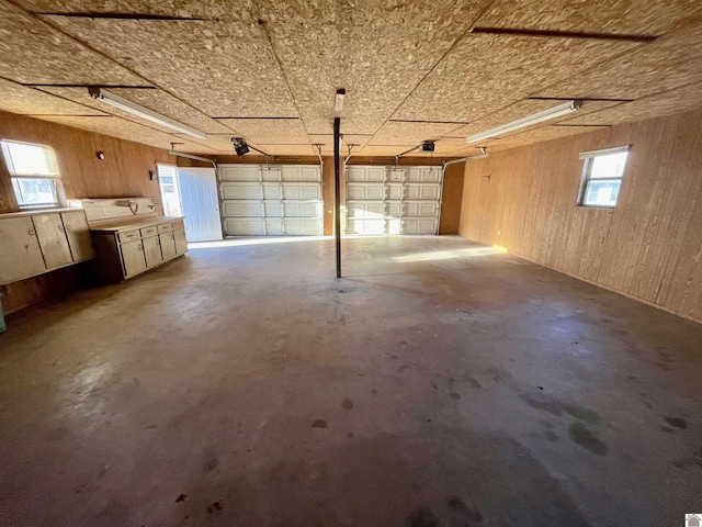 garage with wooden walls and a garage door opener