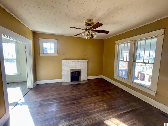 unfurnished living room with a brick fireplace, wood finished floors, and ornamental molding