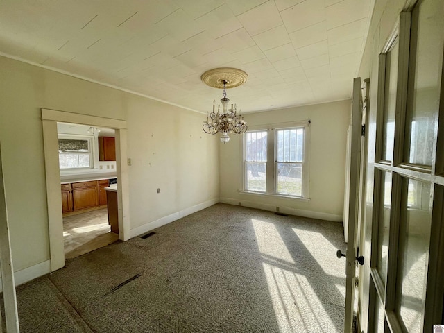 unfurnished dining area featuring an inviting chandelier, carpet, visible vents, and baseboards