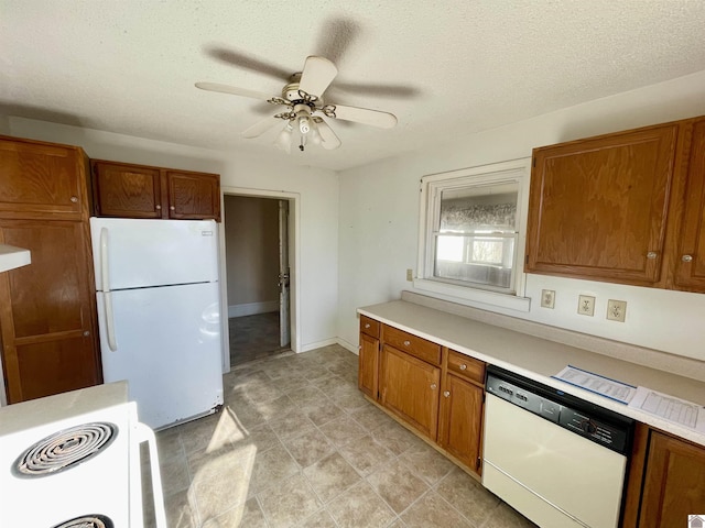 kitchen featuring brown cabinets, white appliances, and light countertops