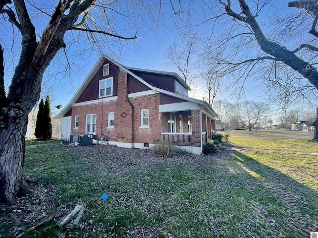 view of home's exterior with a yard and brick siding