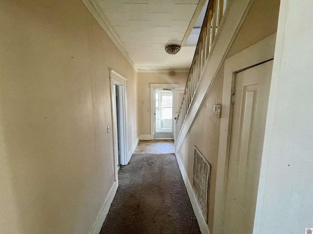 corridor with visible vents, baseboards, stairs, ornamental molding, and carpet flooring