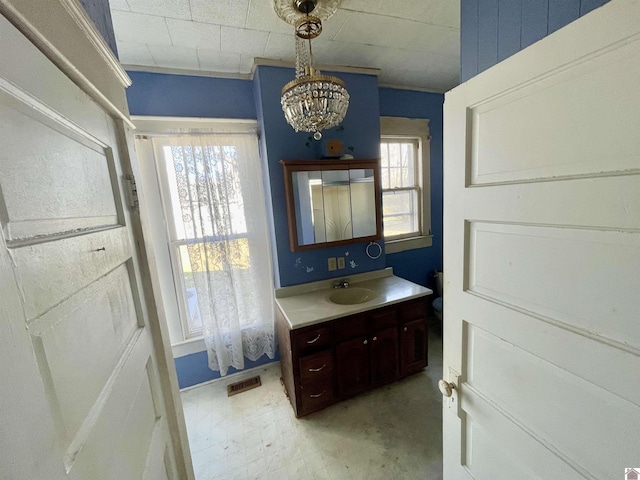 bathroom with vanity, toilet, a healthy amount of sunlight, and visible vents